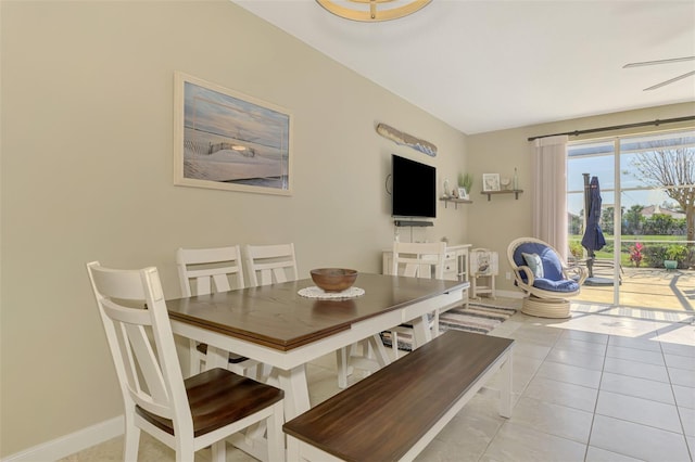 dining room featuring light tile patterned floors and baseboards