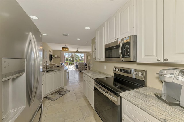 kitchen featuring a sink, visible vents, appliances with stainless steel finishes, and white cabinetry