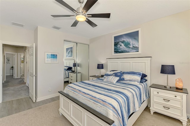 bedroom with visible vents, baseboards, a closet, and a ceiling fan