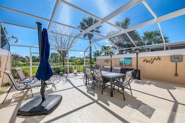 view of patio with glass enclosure and outdoor dining space