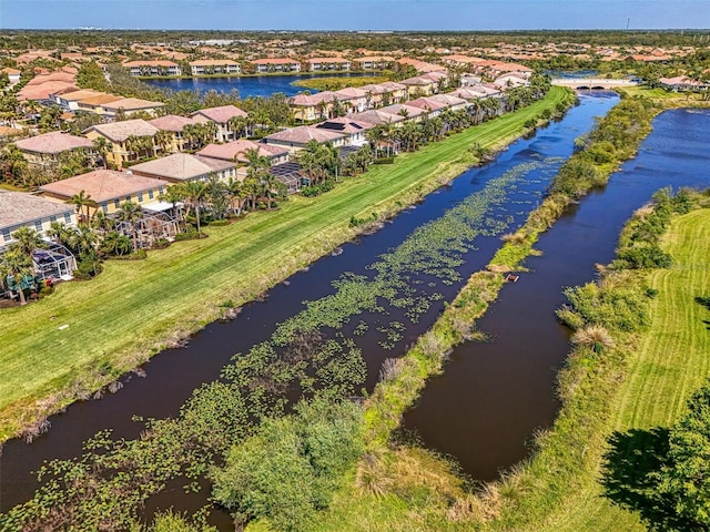 drone / aerial view featuring a residential view and a water view