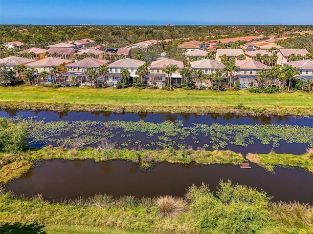 drone / aerial view featuring a residential view and a water view