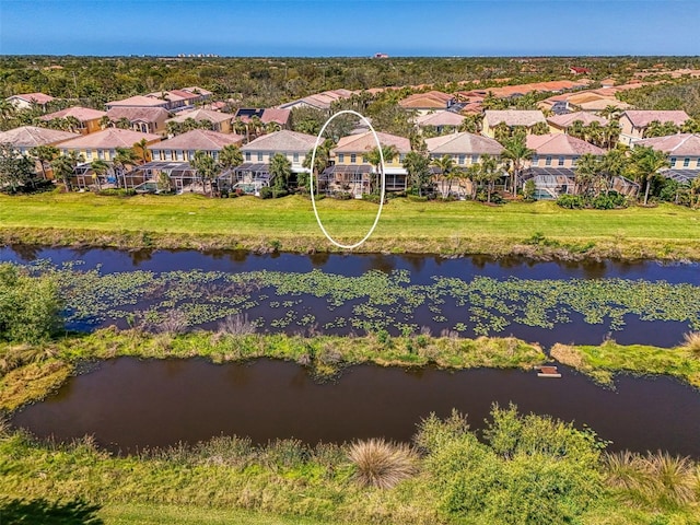 drone / aerial view with a residential view and a water view