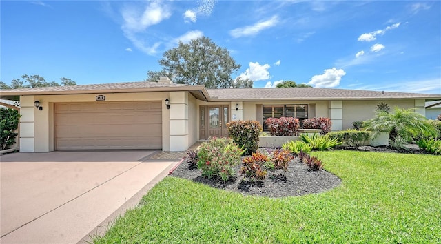 ranch-style home with a front yard, an attached garage, driveway, and stucco siding