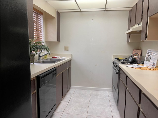 5013 Village Gardens Dr Unit 34, Sarasota, FL 34234 - kitchen with black dishwasher, gas range, under cabinet range hood, light countertops, and light tile patterned floors