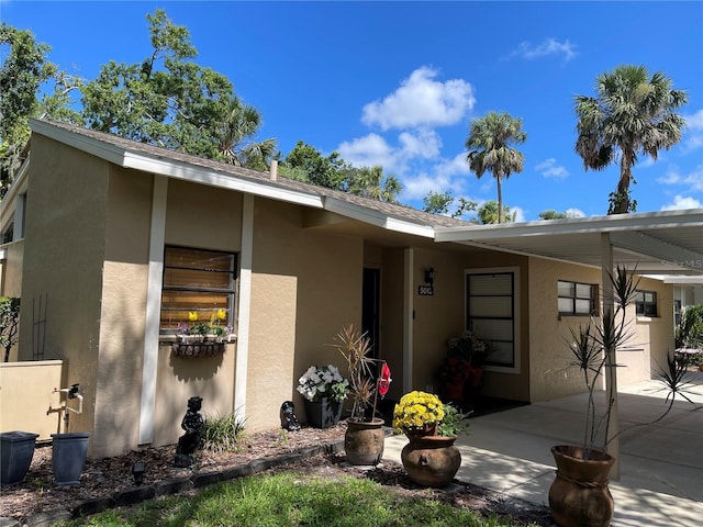 5013 Village Gardens Dr Unit 34, Sarasota, FL 34234 - view of front of house featuring stucco siding and a patio area