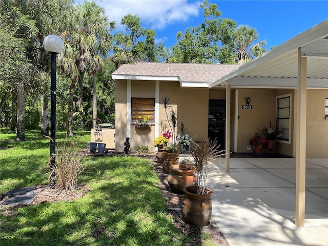 5013 Village Gardens Dr Unit 34, Sarasota, FL 34234 - view of front of home featuring stucco siding and a front yard