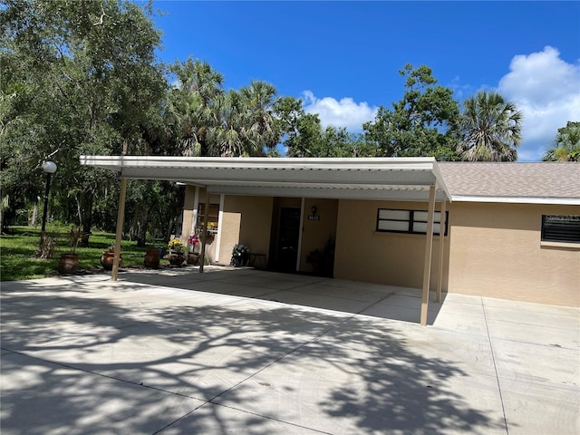 5013 Village Gardens Dr Unit 34, Sarasota, FL 34234 - garage featuring an attached carport