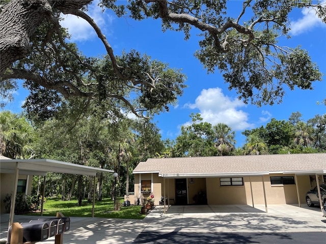 5013 Village Gardens Dr Unit 34, Sarasota, FL 34234 - garage featuring an attached carport and driveway