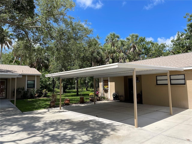 5013 Village Gardens Dr Unit 34, Sarasota, FL 34234 - view of patio featuring an attached carport and concrete driveway