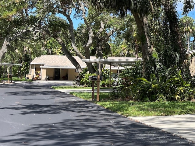 5013 Village Gardens Dr Unit 34, Sarasota, FL 34234 - obstructed view of property featuring stucco siding
