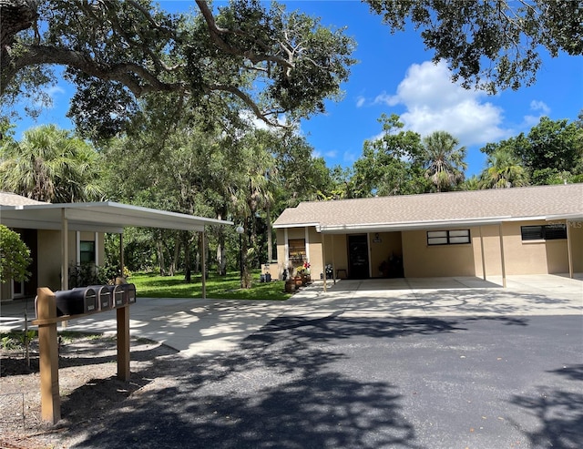 5013 Village Gardens Dr Unit 34, Sarasota, FL 34234 - view of side of home with stucco siding and a carport