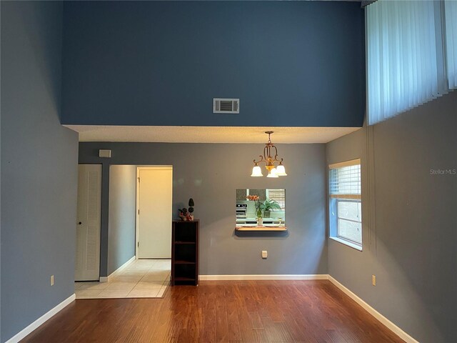 5013 Village Gardens Dr Unit 34, Sarasota, FL 34234 - spare room with wood finished floors and a chandelier