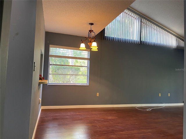 5013 Village Gardens Dr Unit 34, Sarasota, FL 34234 - spare room featuring wood finished floors, a textured ceiling, and a chandelier