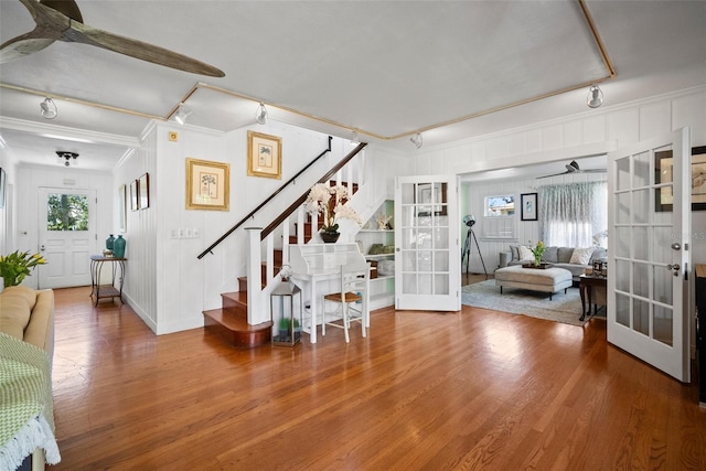 entrance foyer featuring french doors, wood finished floors, a ceiling fan, and stairway