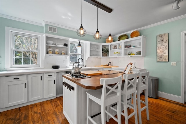 kitchen with open shelves, visible vents, tasteful backsplash, and ornamental molding