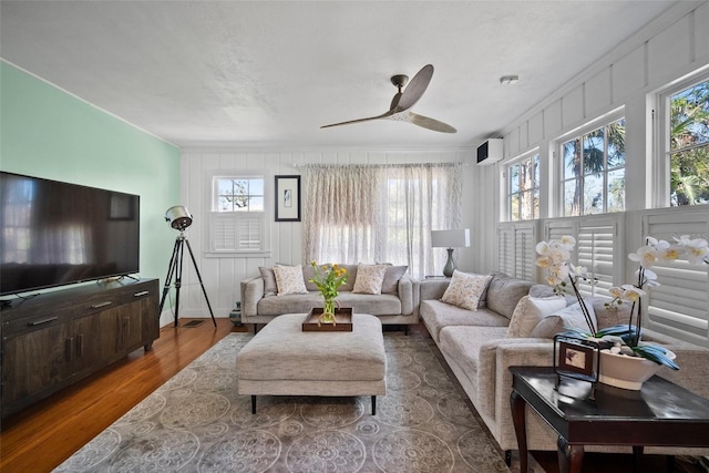 living room featuring ceiling fan and wood finished floors