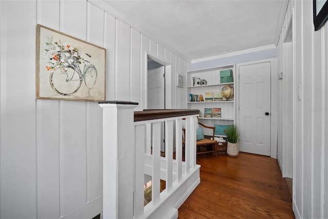 corridor with crown molding and wood finished floors