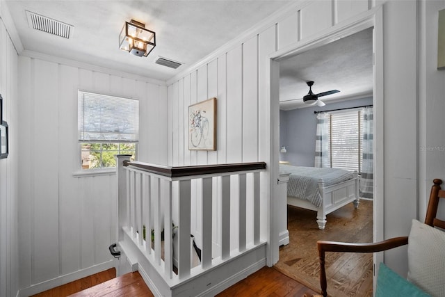 interior space featuring plenty of natural light, wood finished floors, and visible vents