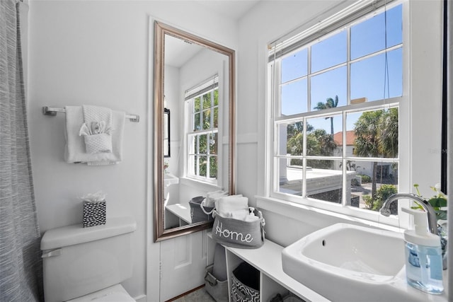 bathroom with toilet and a sink