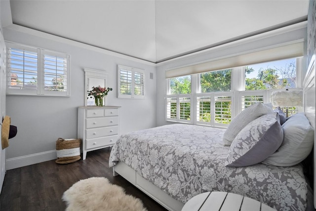 bedroom featuring baseboards, dark wood-style floors, and vaulted ceiling