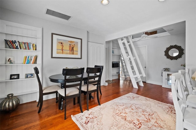 dining space with visible vents, baseboards, and wood finished floors