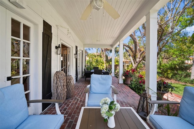 wooden deck with an outdoor living space and ceiling fan