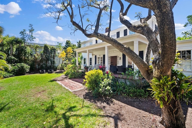 view of front of property with a porch and a front yard