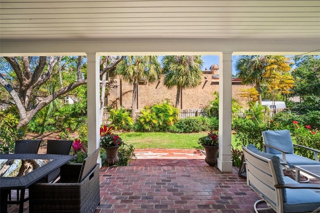 view of patio featuring outdoor dining space and fence