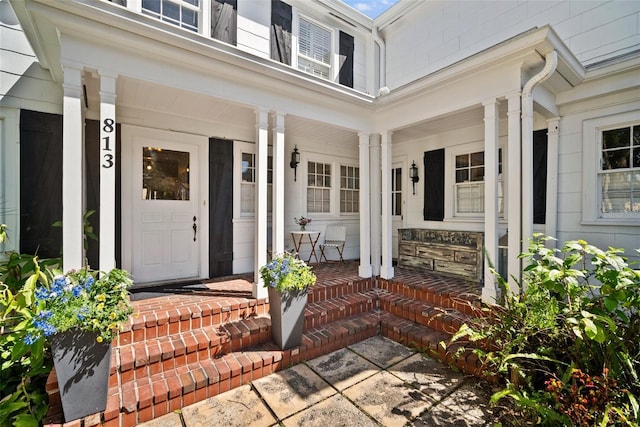 property entrance with stone siding and covered porch