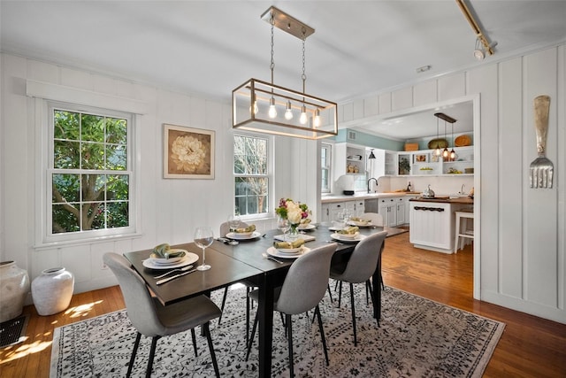 dining area with wood finished floors and a healthy amount of sunlight