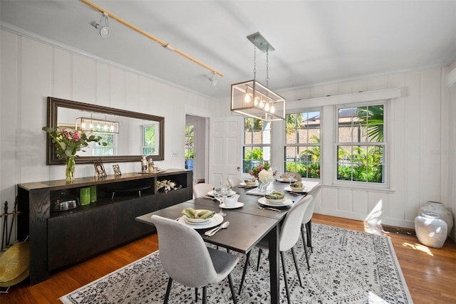 dining area featuring a notable chandelier and wood finished floors