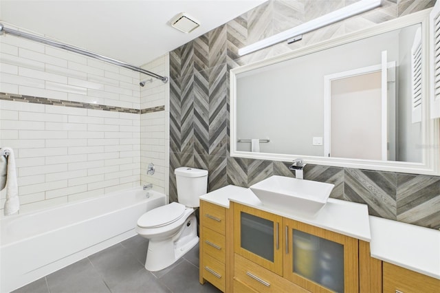 1776 E Cheryl Dr, Winter Park, FL 32792 - full bath with tile patterned floors, toilet, vanity, bathing tub / shower combination, and tile walls