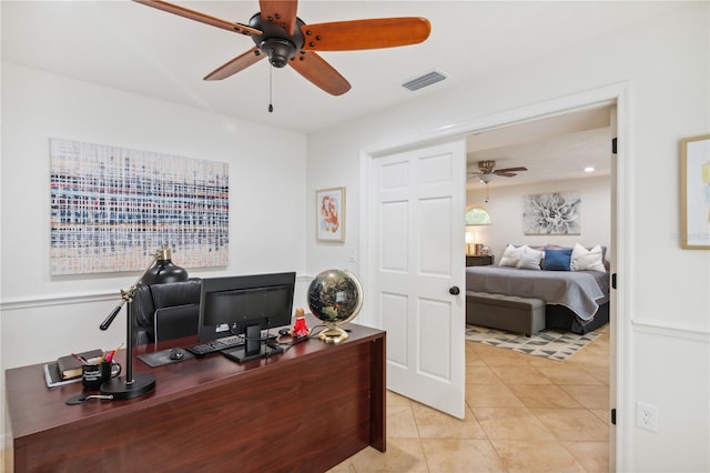 office area with light tile patterned flooring, visible vents, and ceiling fan