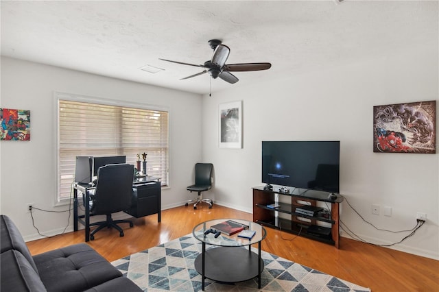 home office featuring baseboards, wood finished floors, and a ceiling fan