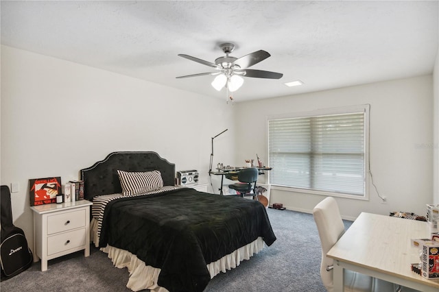 bedroom with dark carpet, baseboards, and ceiling fan