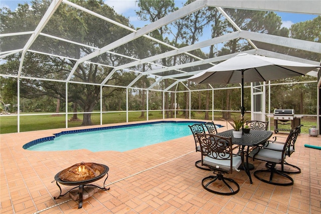 outdoor pool featuring glass enclosure, a yard, a fire pit, a patio area, and a grill