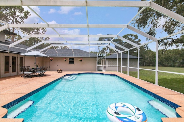 outdoor pool with a patio area, french doors, and a lanai