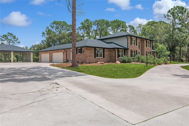 view of front of property with a garage, brick siding, concrete driveway, and a front yard