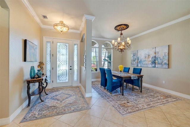 foyer featuring an inviting chandelier, light tile patterned floors, ornamental molding, and baseboards