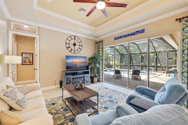tiled living area featuring a raised ceiling, a sunroom, ceiling fan, and visible vents