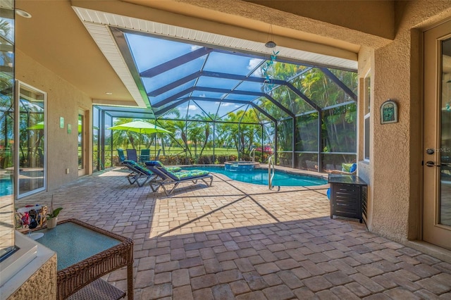 view of swimming pool with glass enclosure, a pool with connected hot tub, and a patio area