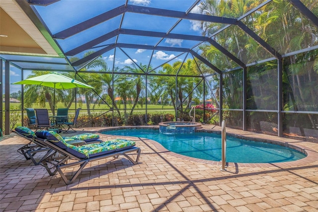 view of swimming pool featuring a pool with connected hot tub, a lanai, and a patio