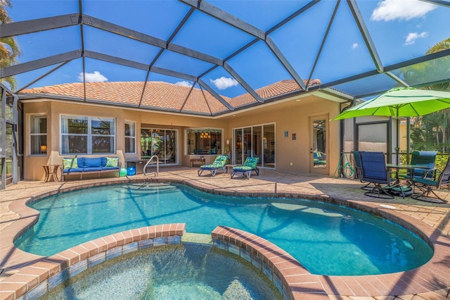view of pool with a pool with connected hot tub and a patio area