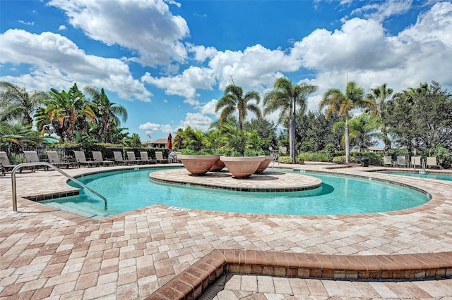 community pool featuring fence and a patio