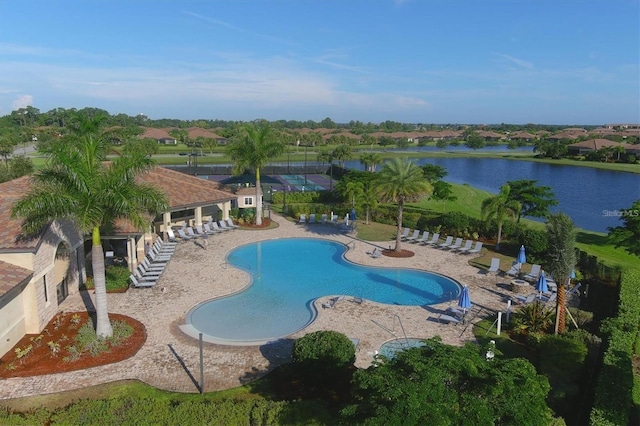 community pool with a water view and a patio