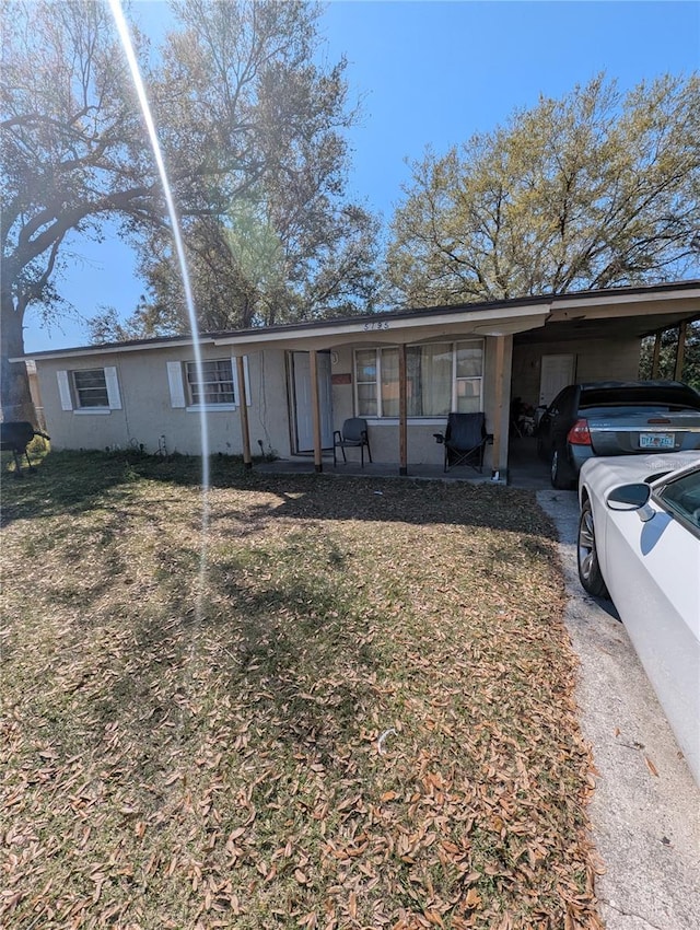 5195 Edwina St, Orlando, FL 32811 - ranch-style house with a carport and driveway