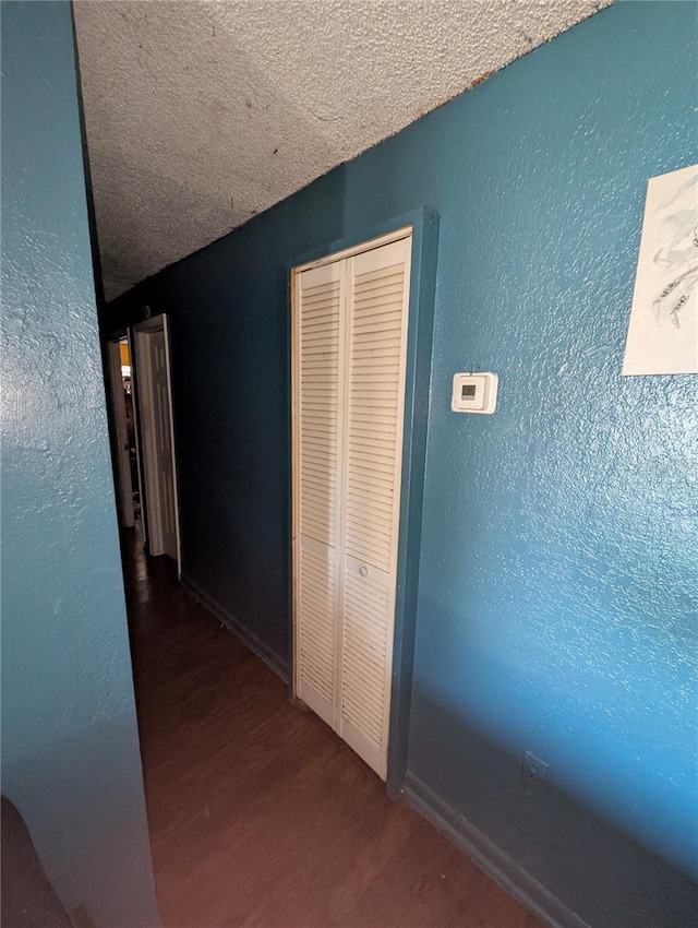 5195 Edwina St, Orlando, FL 32811 - corridor featuring a textured ceiling, a textured wall, and wood finished floors