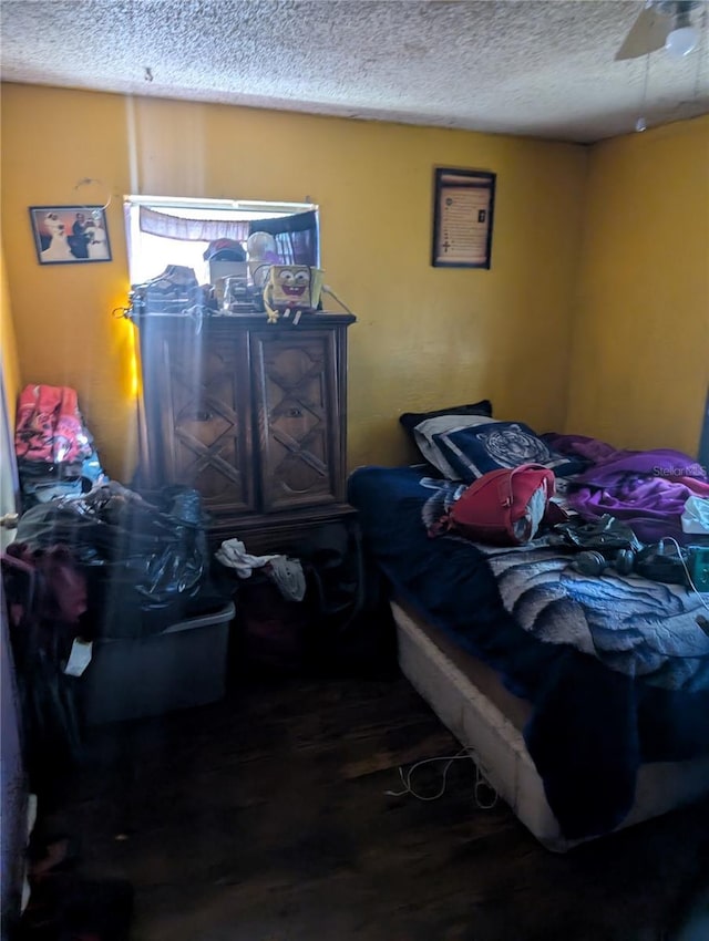 5195 Edwina St, Orlando, FL 32811 - bedroom with wood finished floors and a textured ceiling