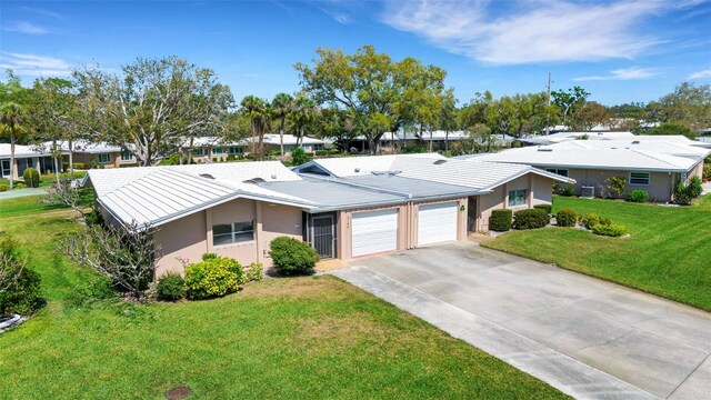 3140 Village Green Dr Unit 1119, Sarasota, FL 34239 - single story home featuring stucco siding, driveway, an attached garage, a front yard, and a tile roof